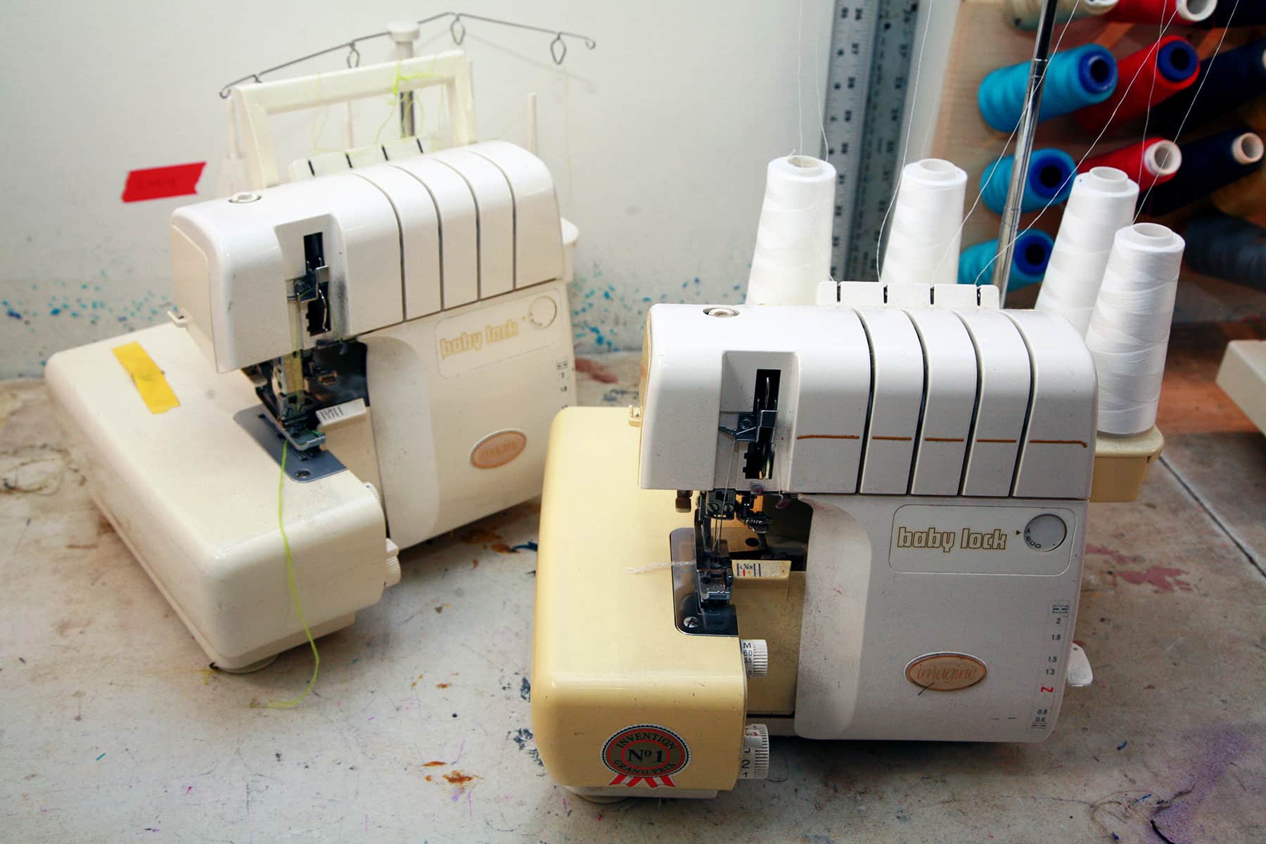 Two Babylock Imagine sergers are pictured on a work table.