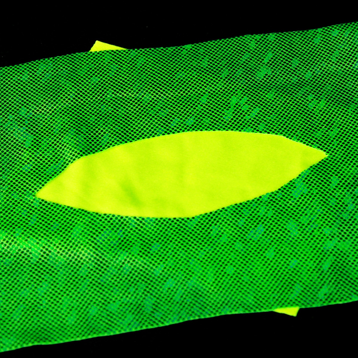 A rectangle of sparkly bright green spandex has a hole cut out of it, with yellow spandex showing from underneath.