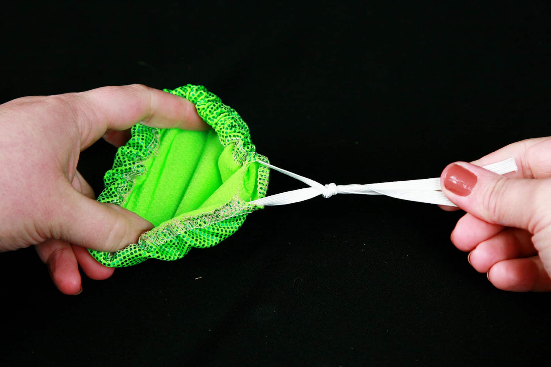 A length of elastic being tied off, per the instructions.