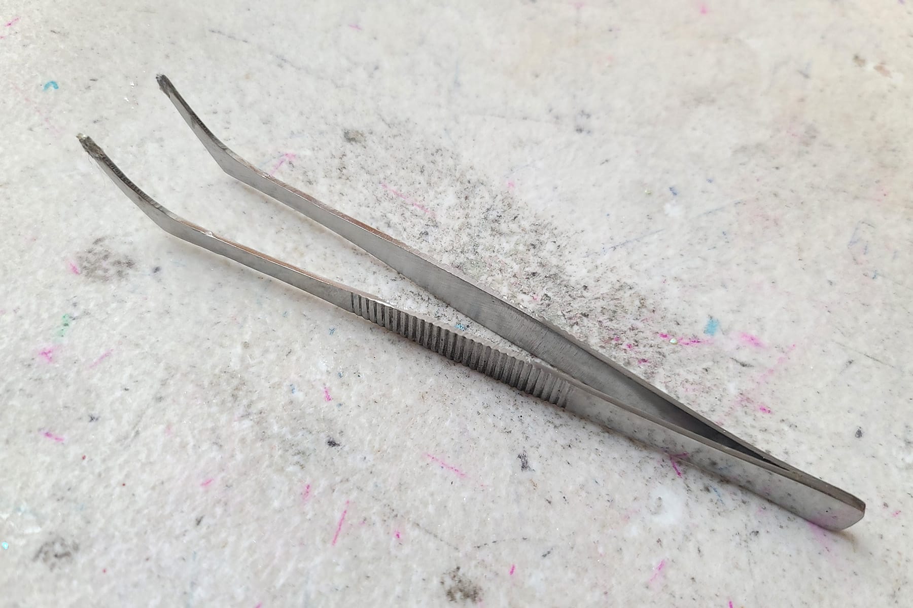 A long pair of silver coloured craft tweezers.