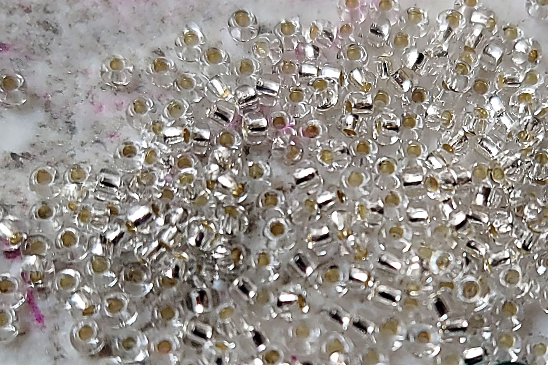 A very close up view of a pile of clear seed beads.