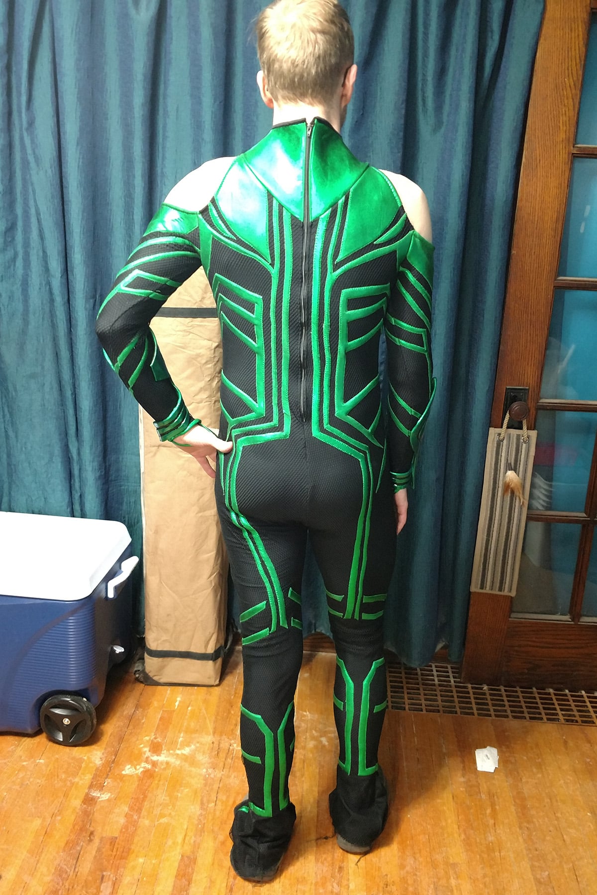 A back view of a blonde man wearing an MCU Hela costume.