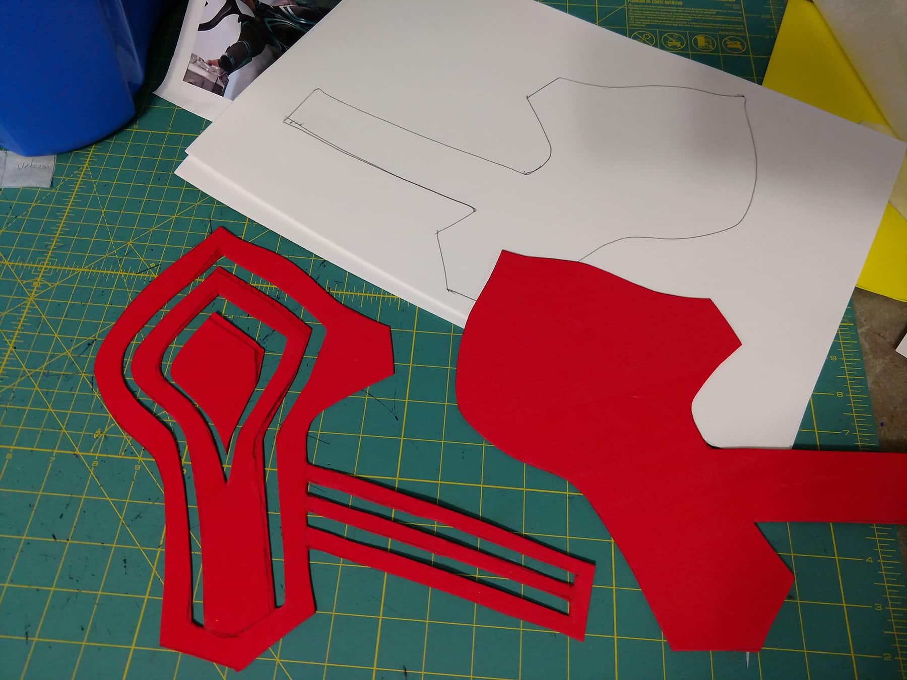 Two pieces of red craft foam have been cut into a base pattern piece, and one with channels cut out of it.