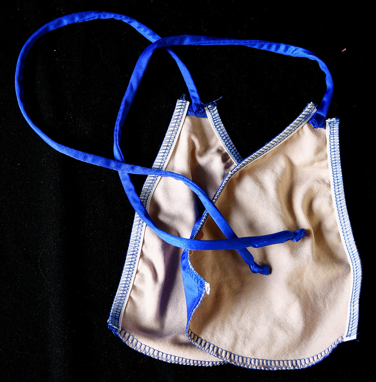 Two bikini triangles with the elastic sewn in, wrong sides facing.