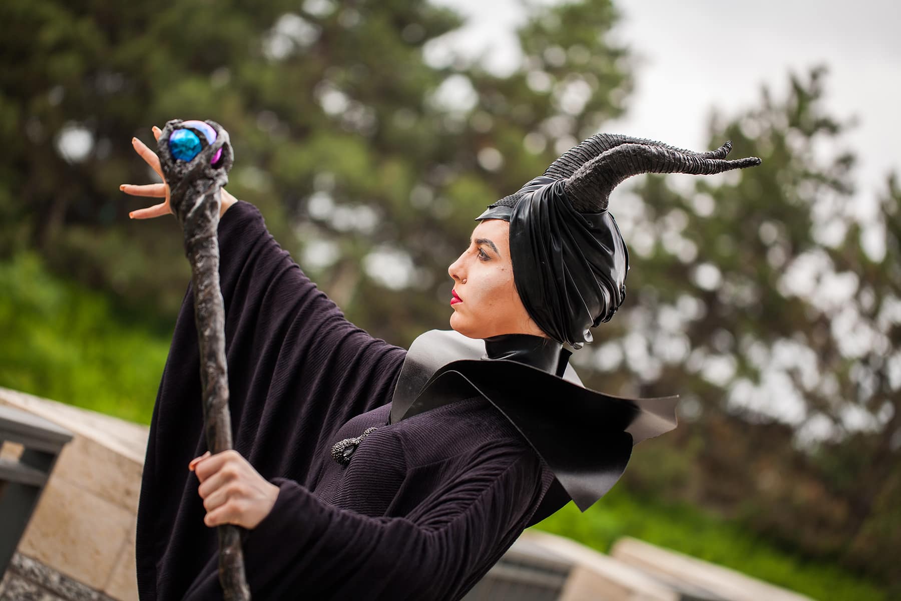 A close up view of a cosplayer dressed as Maleficent.