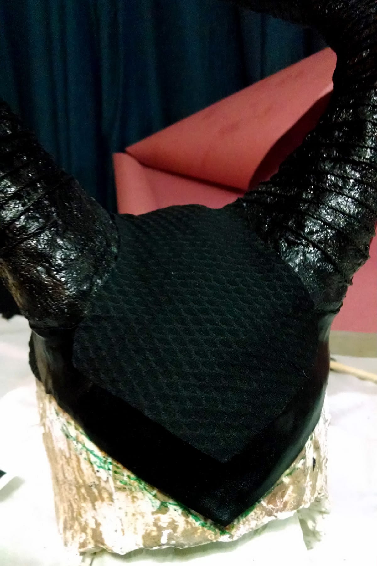 The bottom edge of Maleficent's Headpiece has been trimmed with shiny black metallic spandex.