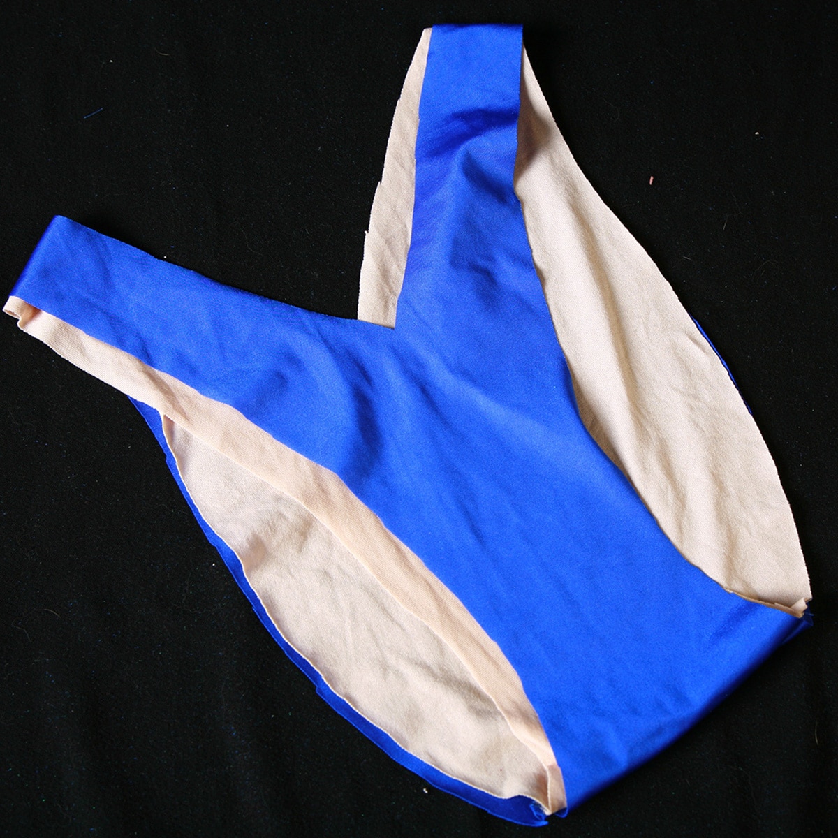 A blue v cut bikini bottom, with no elastic in it.