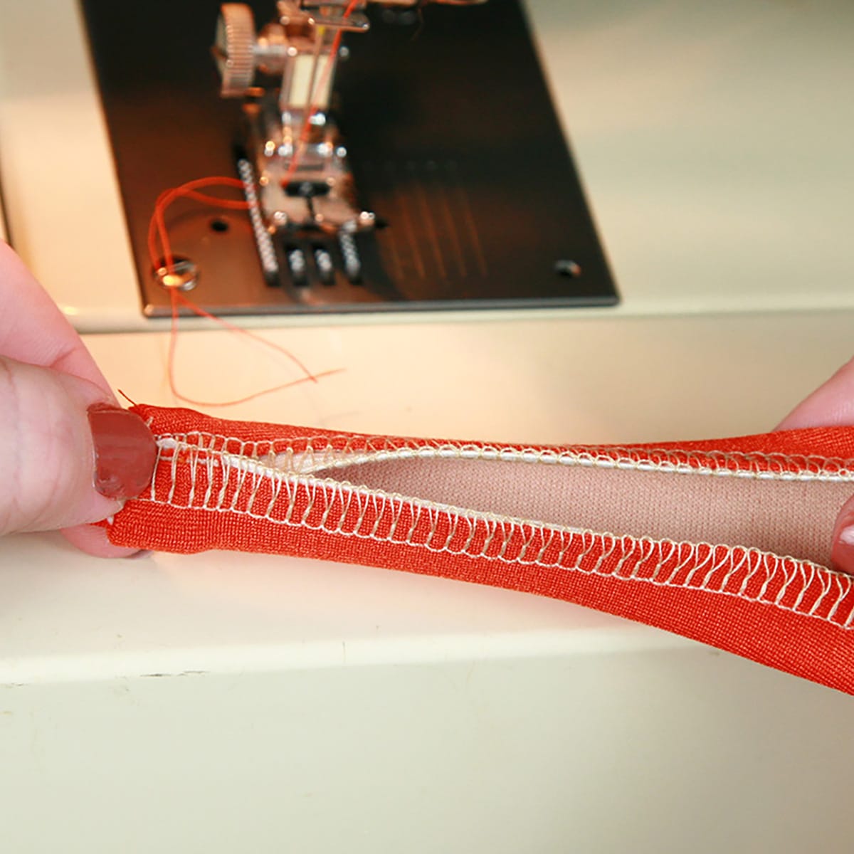 Elastic being applied to either side of a strap, as described in the post.