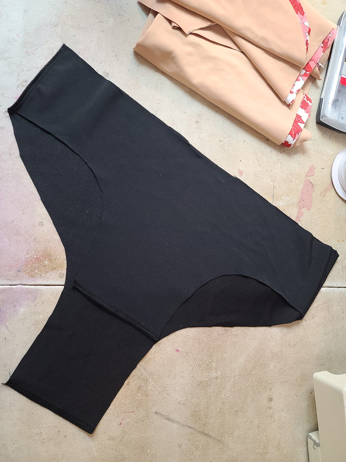 Side seams sewn on black skating briefs for a bodyshirt.