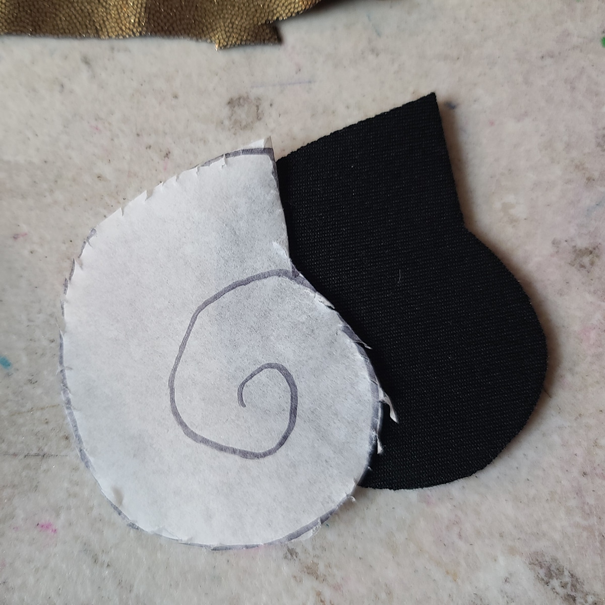 The shell pattern and a piece of bra padding have both been cut to shape and size.