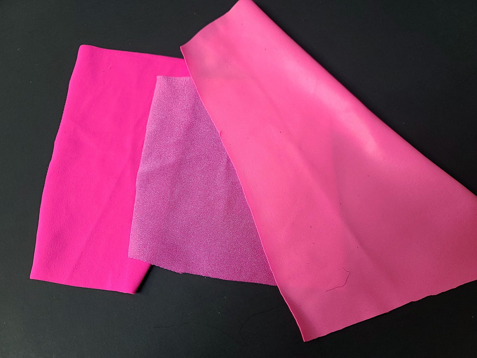 3 pieces of pink Lycra® with various finishes.