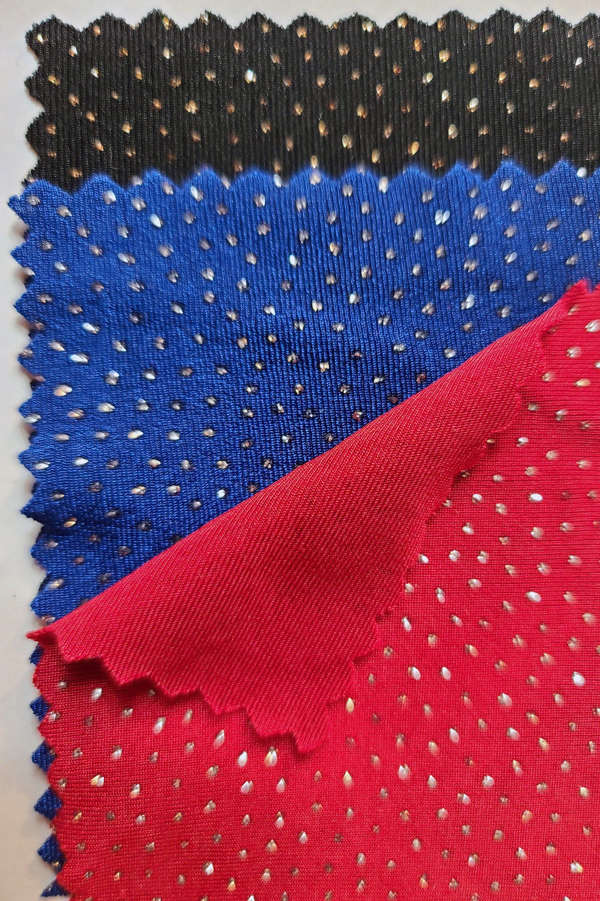 Black, blue, and red pieces of Slinky fabric.