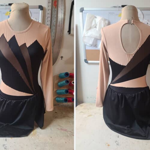 Front and back views of an art deco inspired skating dress. It's black with black mesh inserts.