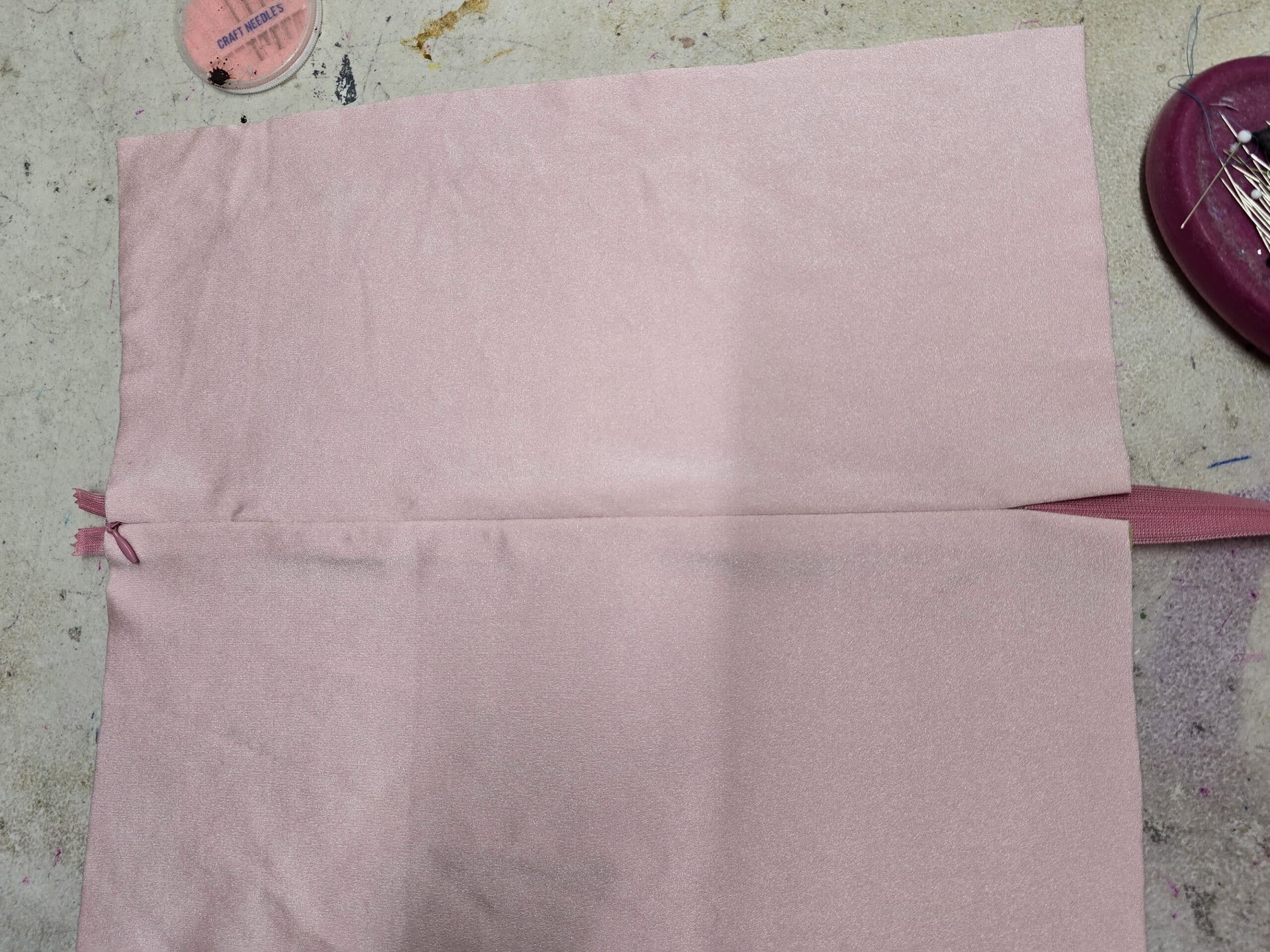 A pink invisible zipper sewn into 2 pieces of pink spandex.