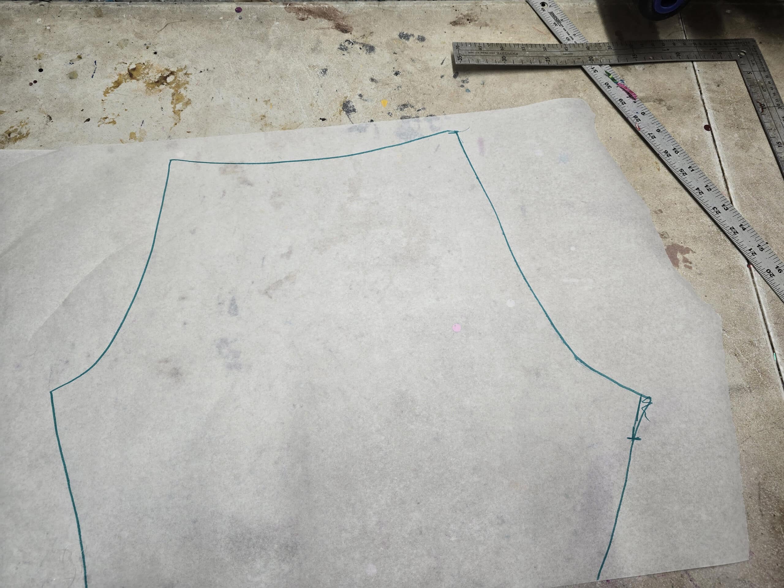 The top of a tights pattern, drawn out on medical exam table paper.