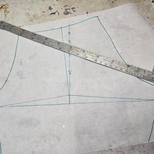 A homemade booty shorts pattern on a sewing table.